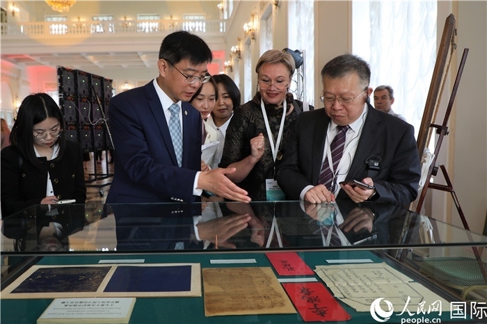 中俄圖書館論壇嘉賓共同參觀由俄羅斯國立列寧圖書館舉辦的館藏中國古籍善本圖書展。人民網(wǎng)記者 隋鑫攝）