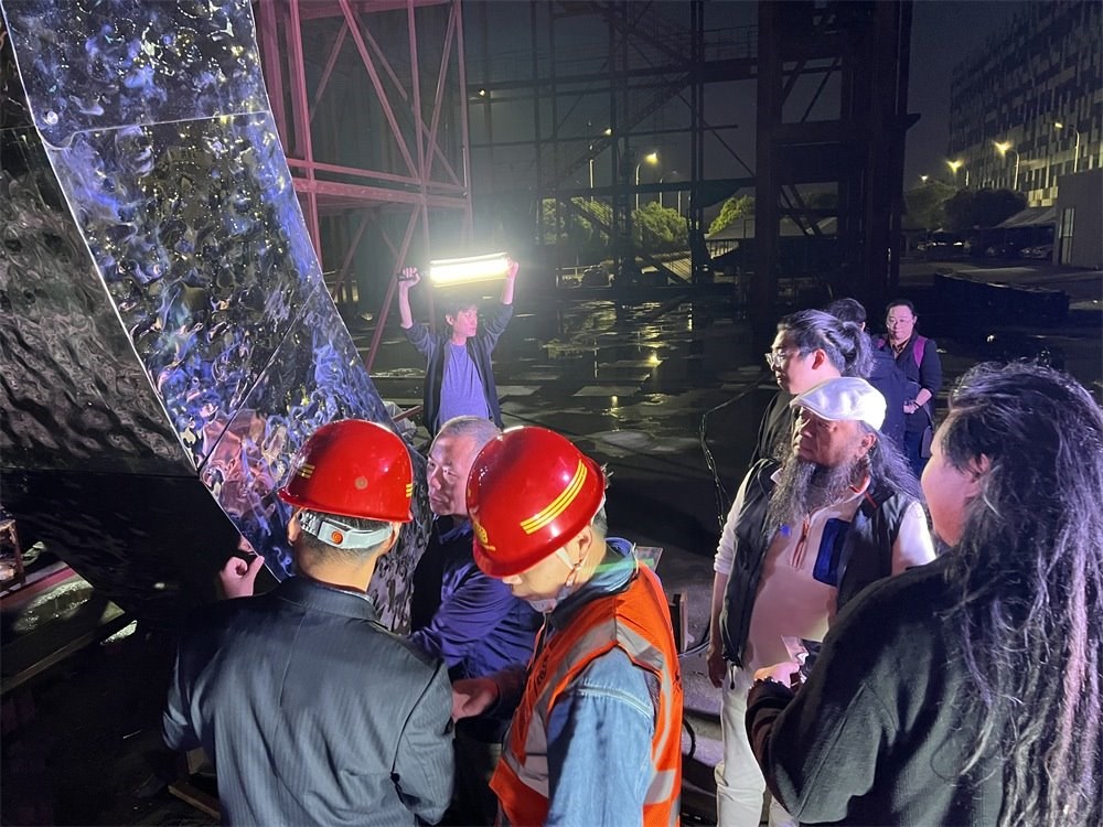 林崗（右二）和團(tuán)隊(duì)查看主火炬制作進(jìn)度。受訪者供圖