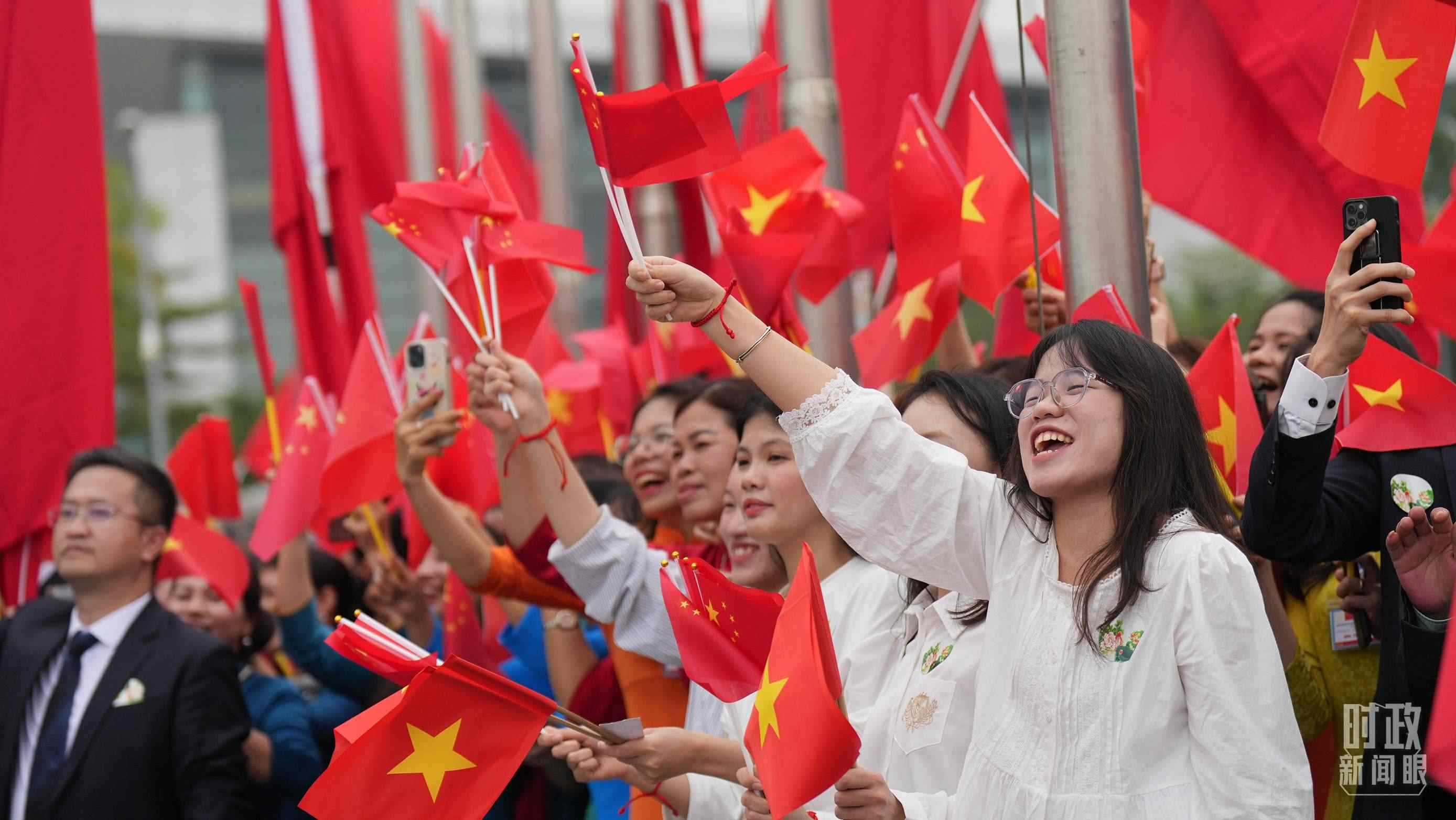 △人們揮舞兩國旗幟歡迎習近平訪越。（總臺國廣記者李晉拍攝）