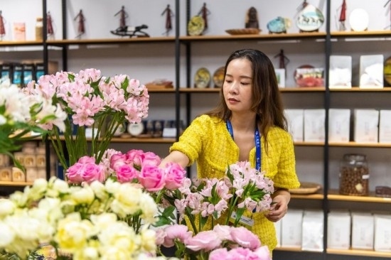 2023年7月1日，在位于湖南省長(zhǎng)沙市的湖南高橋大市場(chǎng)，中非經(jīng)貿(mào)博覽會(huì)常設(shè)展館展區(qū)肯尼亞館工作人員在整理產(chǎn)自非洲的鮮花。新華社記者 陳思汗 攝