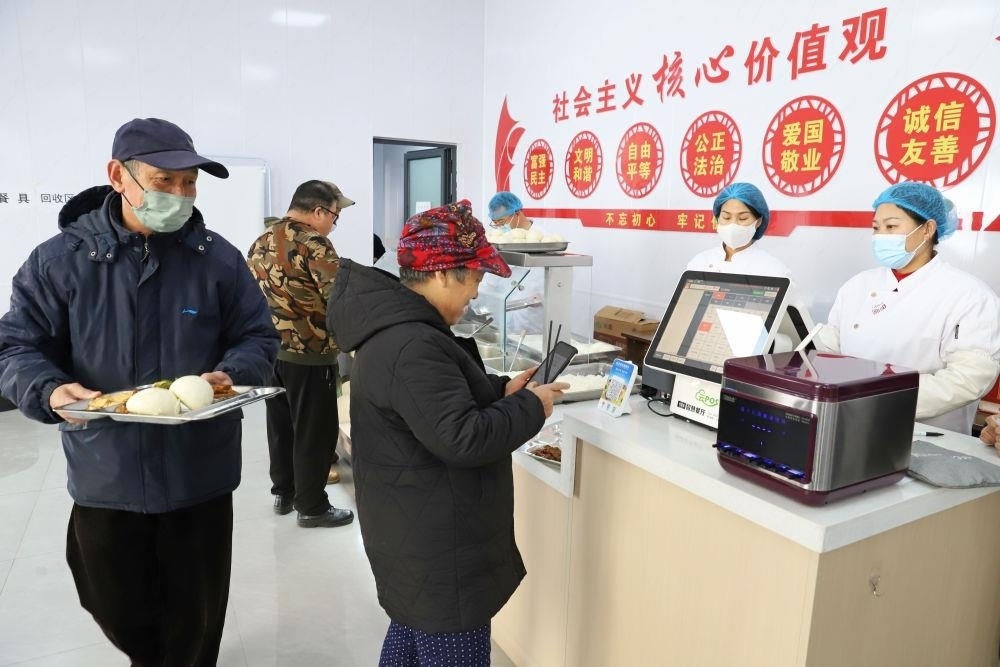 △2024年2月1日，市民在河北涿州市雙塔街道永濟(jì)秀園小區(qū)便民食堂內(nèi)購買午餐。