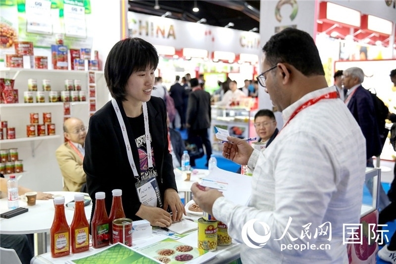 圖為中國參展企業(yè)代表與采購商交流。人民網(wǎng) 塔里克·易卜拉欣攝