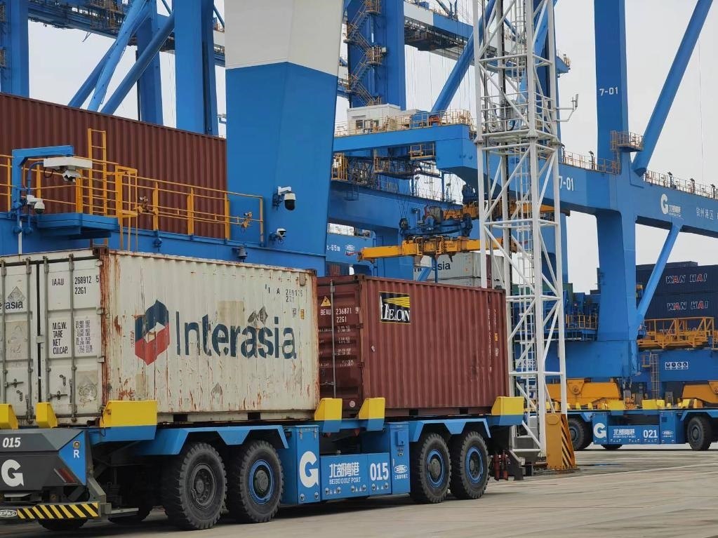 在欽州自動化集裝箱碼頭，智能導(dǎo)引運(yùn)輸車在運(yùn)送集裝箱。新華社記者趙歡 攝