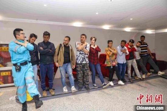 5月9日，工作人員指導(dǎo)留學(xué)生練習(xí)逃生技巧。張鷹 攝