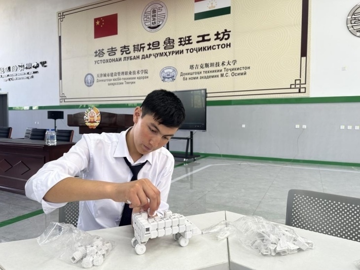 在塔吉克斯坦魯班工坊內(nèi)，學(xué)員正在操作能力源創(chuàng)新套件。本報(bào)記者 屈佩 攝