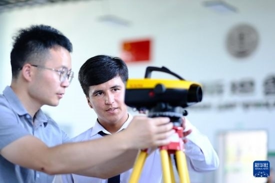 6月14日，在塔吉克斯坦首都杜尚別的魯班工坊，來自天津城市建設(shè)管理職業(yè)技術(shù)學(xué)院的老師（左）指導(dǎo)學(xué)生。新華社記者 鄭開君 攝
