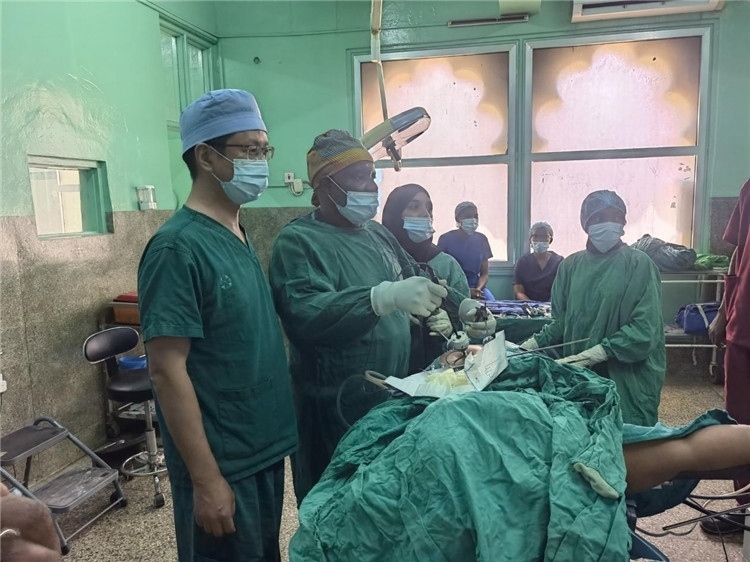 隊(duì)長(zhǎng)蔣國(guó)慶（左一）關(guān)注當(dāng)?shù)蒯t(yī)生手術(shù)情況。中國(guó)援桑醫(yī)療隊(duì)供圖