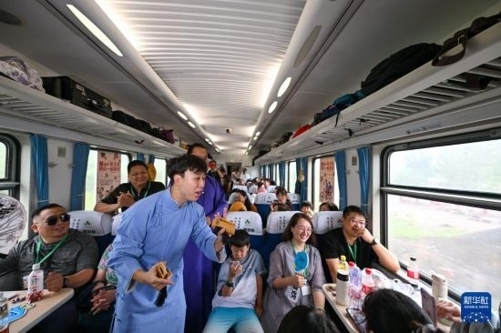 9月7日，相聲演員在S910列車(chē)上為旅客表演快板。