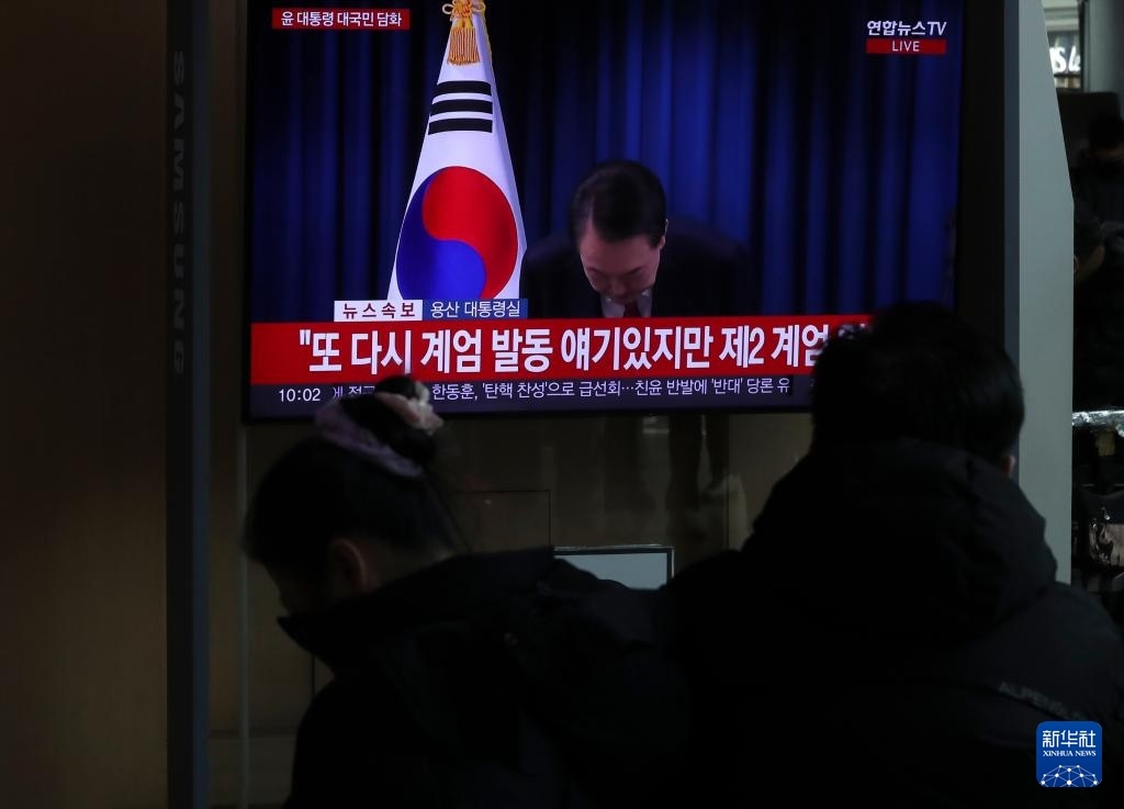 12月7日，在韓國首爾火車站，民眾觀看總統尹錫悅發(fā)表講話的電視畫面。新華社記者 姚琪琳 攝