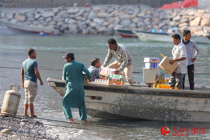 當(dāng)?shù)厝藗冊谶\送生活物資。人民網(wǎng) 塔里克·易卜拉欣攝