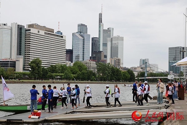 來自美國的快樂龍舟隊選手們正在登船準(zhǔn)備參賽。人民網(wǎng)記者 劉仲華攝